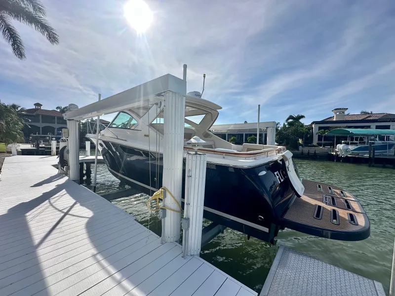 Slide: The Image of 2012 Tiara Yachts 3100 Coronet on lift at sunny marina dock. - 5