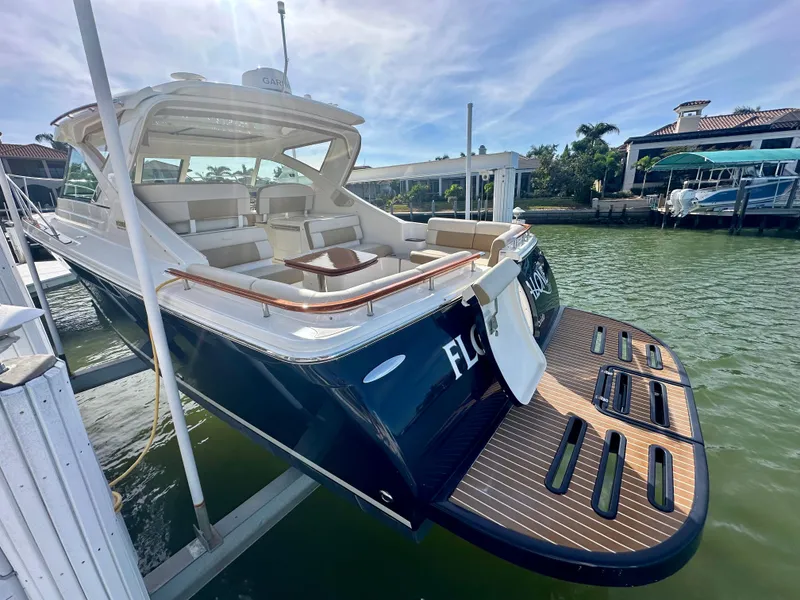 Slide: The Image of 2012 Tiara Yachts 3100 Coronet docked, showcasing elegant design and spacious seating. - 6