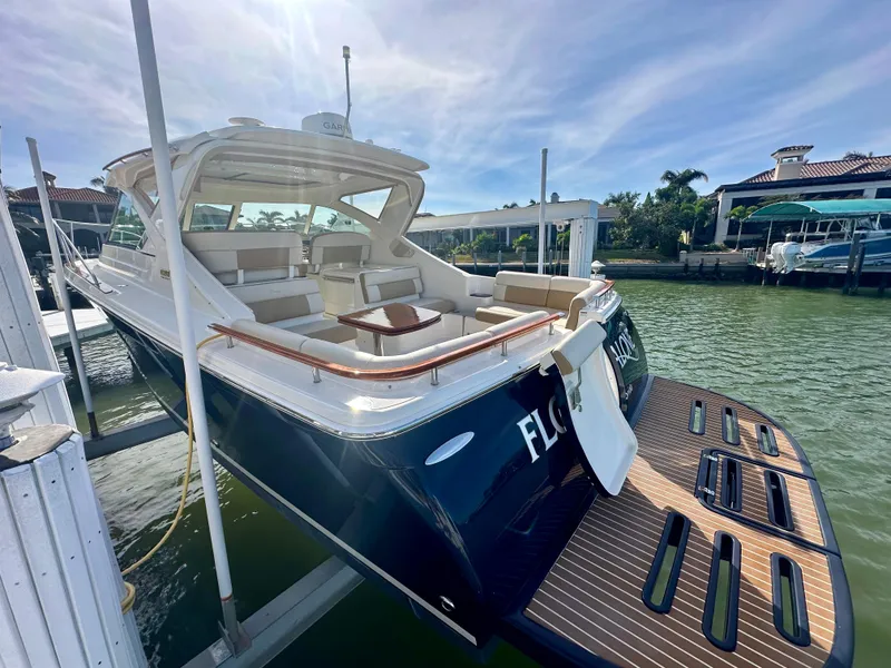 Slide: The Image of 2012 Tiara Yachts 3100 Coronet docked, showcasing elegant design and spacious seating. - 7