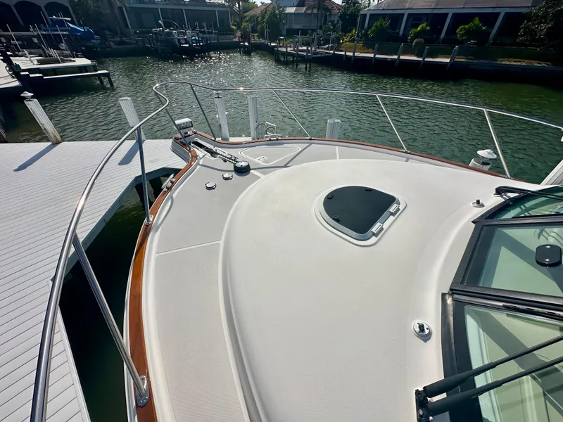 Slide: The Image of 2012 Tiara Yachts 3100 Coronet docked, showcasing sleek deck design and waterfront view. - 8