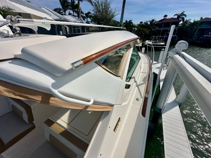 Slide: The Image of 2012 Tiara Yachts 3100 Coronet docked, showcasing sleek design and luxury features. - 9