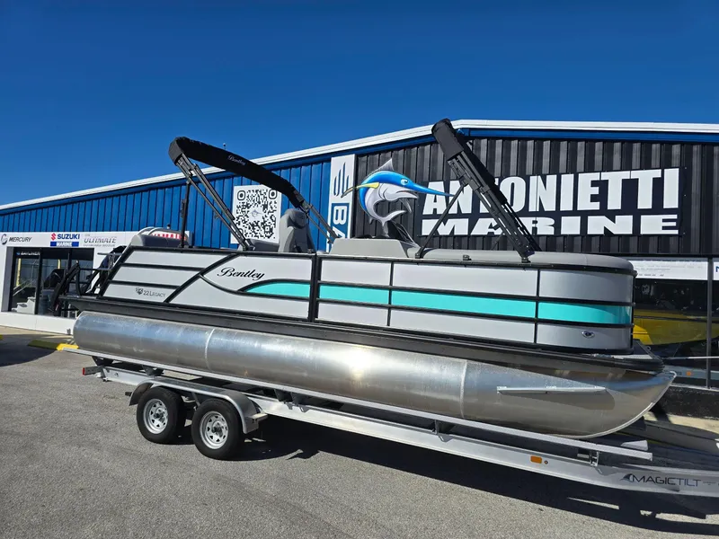 Slide: The Image of 2025 Bentley Pontoons 223 Quad Swingback Legacy Tritoon displayed at dealership. - 1