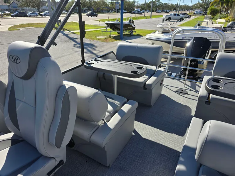 Slide: The Image of 2025 Bentley Pontoons 223 Quad Swingback Legacy Tritoon interior with luxurious seating and table. - 11
