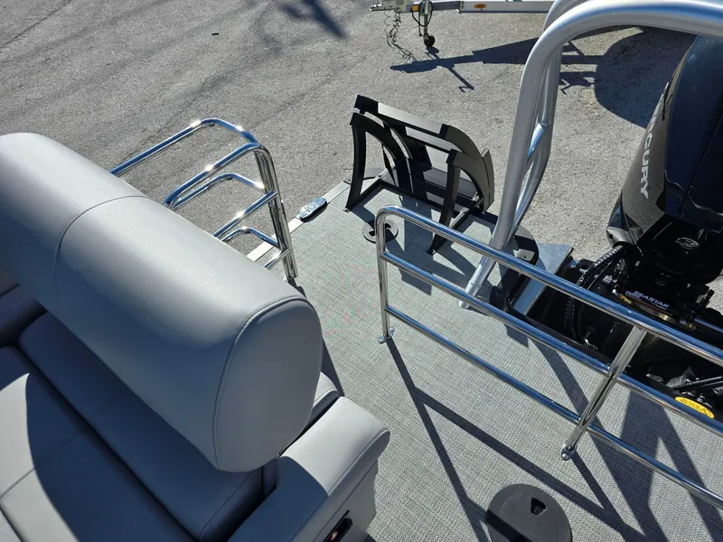 Slide: The Image of 2025 Bentley Pontoons 223 Quad Swingback Legacy Tritoon deck with seating and motor view. - 12