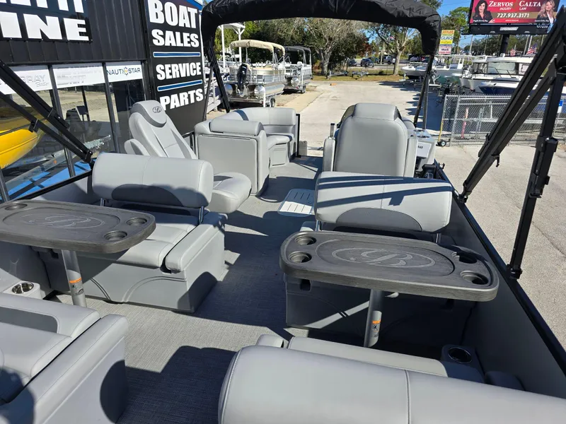 Slide: The Image of 2025 Bentley Pontoons 223 Quad Swingback Legacy Tritoon interior with luxurious seating and tables. - 13