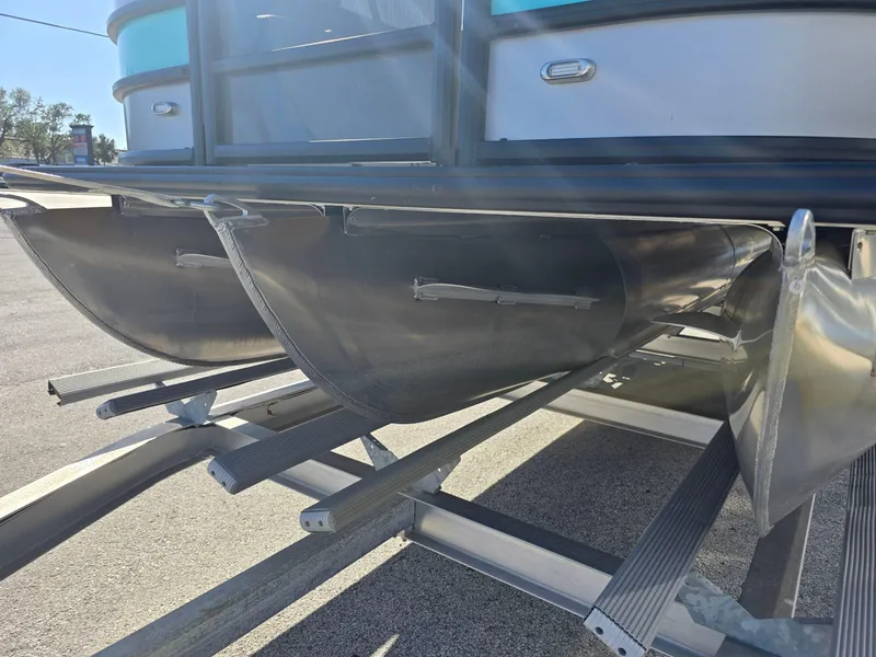 Slide: The Image of 2025 Bentley Pontoons 223 Quad Swingback Legacy Tritoon on trailer, close-up view. - 19