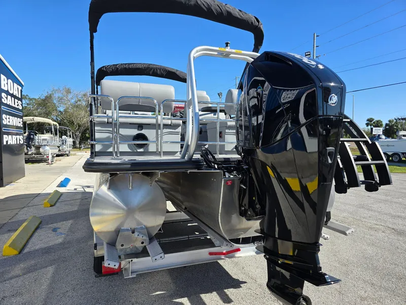 Slide: The Image of 2025 Bentley Pontoons 223 Quad Swingback Legacy Tritoon with powerful outboard motor. - 3