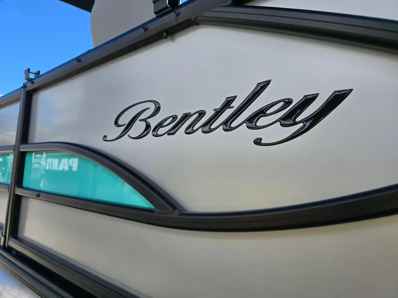 Slide: The Image of 2025 Bentley Pontoons 223 QUAD SWINGBACK LEGACY TRITOON logo on boat exterior. - 4
