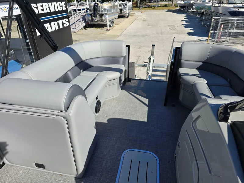 Slide: The Image of 2025 Bentley Pontoons 223 Quad Swingback Legacy Tritoon interior with gray seating and spacious layout. - 8