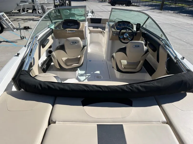 Slide: The Image of 2017 Chaparral H20 boat interior with beige seating and modern dashboard. - 7