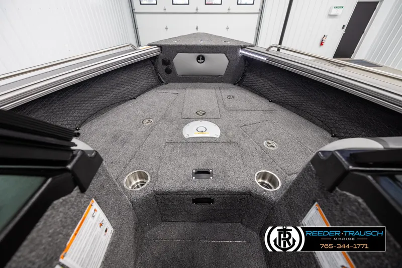 Slide: The Image of 2025 Lund 1975 Tyee boat interior with carpeted deck and cup holders. - 14