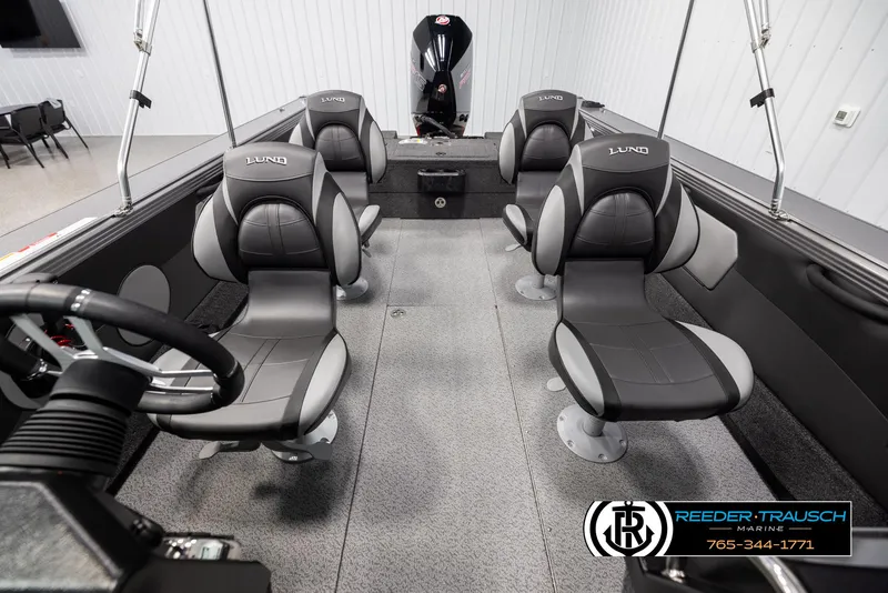 Slide: The Image of Interior of 2025 Lund 1975 Tyee boat with four black seats and steering wheel. - 16
