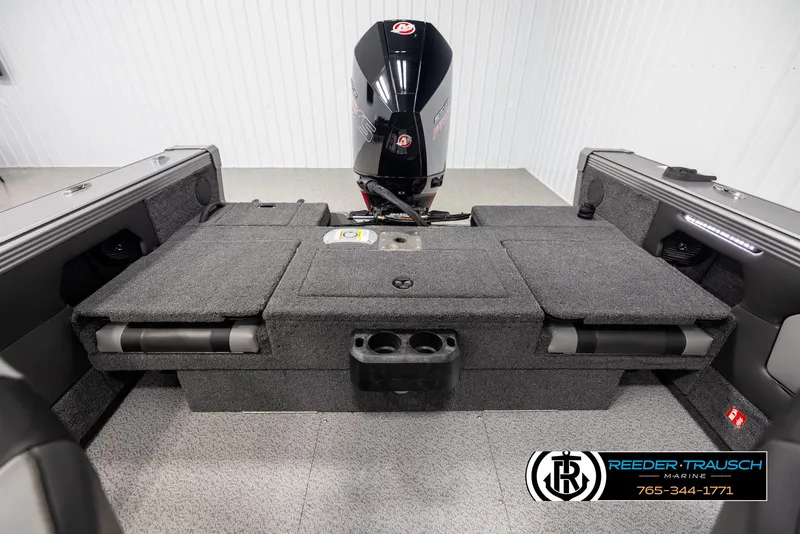 Slide: The Image of 2025 Lund 1975 Tyee boat interior with motor, gray seating, and storage compartments. - 18