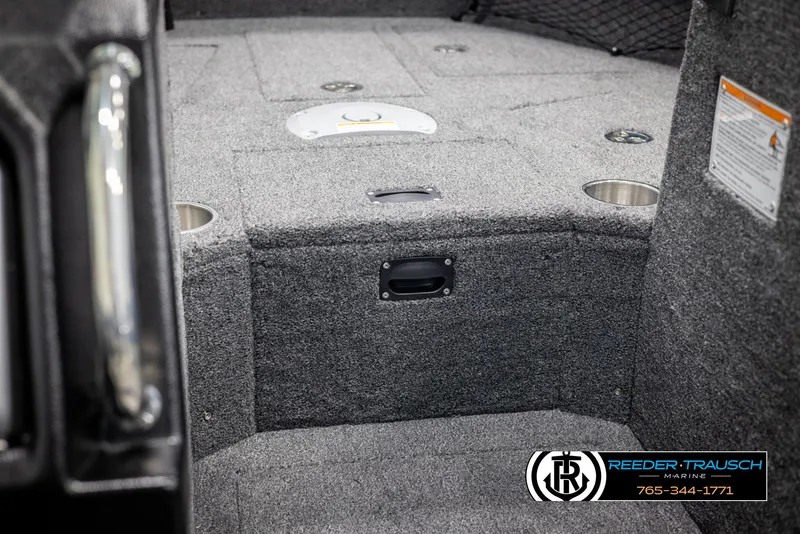 Slide: The Image of Interior of 2025 Lund 1975 Tyee boat with carpeted flooring and storage compartments. - 24