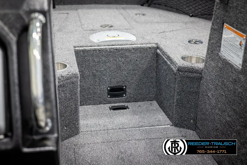 Slide: The Image of Interior of 2025 Lund 1975 Tyee boat with carpeted flooring and storage compartments. - 25