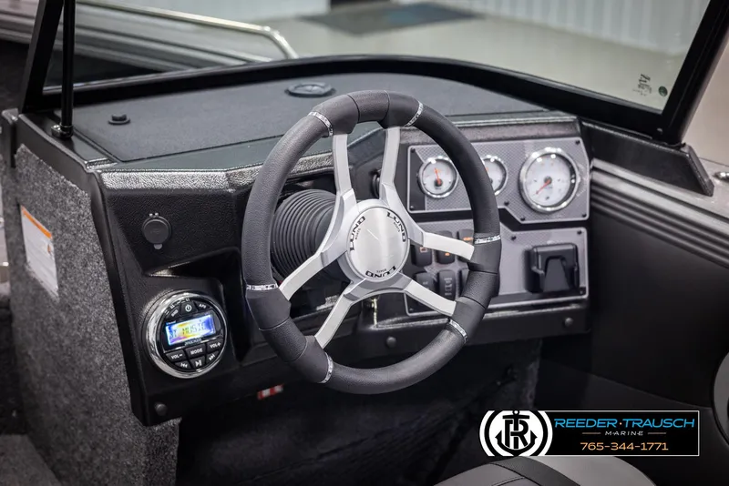 Slide: The Image of 2025 Lund 1975 Tyee boat dashboard with steering wheel and gauges. - 27