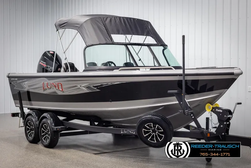 Slide: The Image of 2025 Lund 1975 Tyee boat with canopy on trailer in showroom. - 3