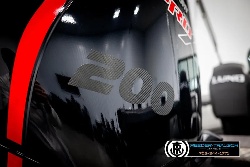 Slide: The Image of Close-up of a 2025 Lund 1975 Tyee boat engine with "200" decal. - 44