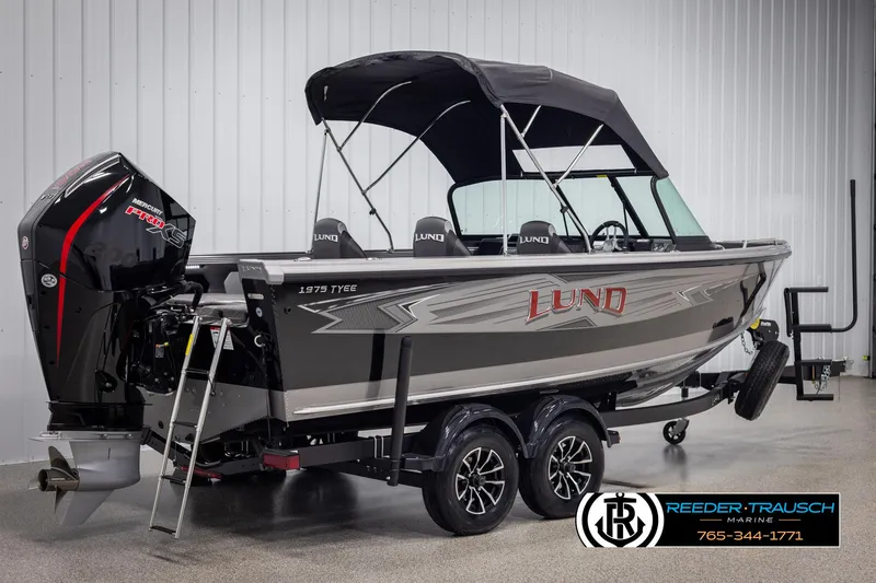 Slide: The Image of 2025 Lund 1975 Tyee boat with canopy and trailer in showroom. - 5