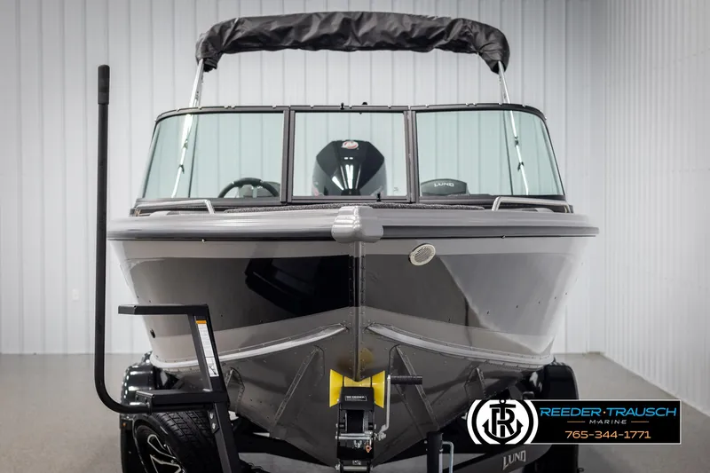 Slide: The Image of 2025 Lund 1975 Tyee boat in showroom, front view, black exterior, on trailer. - 7