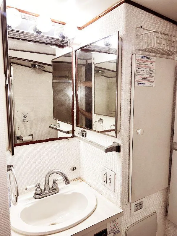Slide: The Image of 1975 Hatteras 36 Convertible yacht bathroom with sink and mirrored cabinet. - 18
