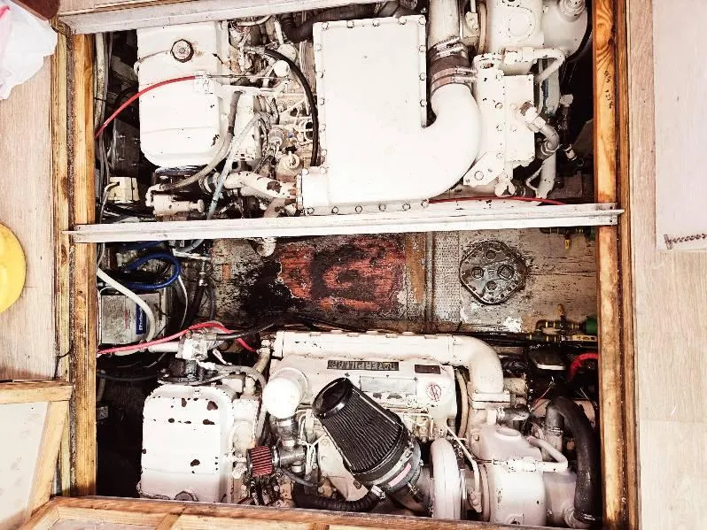 Slide: The Image of Engine compartment of a 1975 Hatteras 36 Convertible boat, showcasing dual engines. - 20