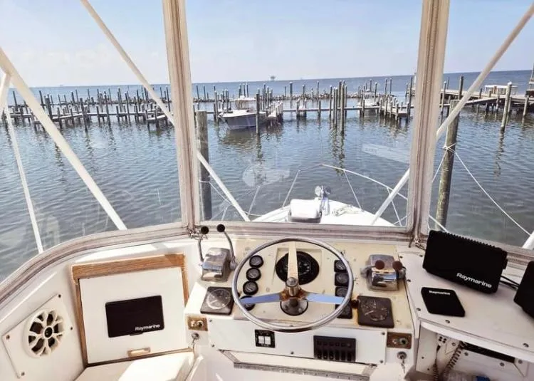 Slide: The Image of Helm view of 1975 Hatteras 36 Convertible at marina. - 3