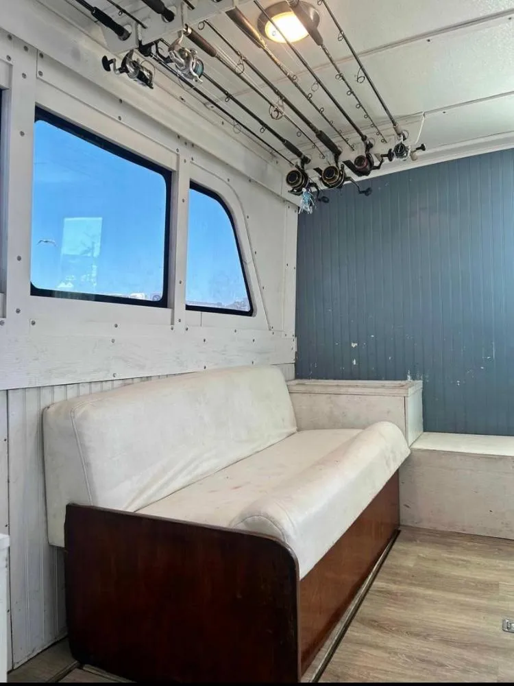 Slide: The Image of Interior of 1975 Hatteras 36 Convertible with fishing rods and white sofa. - 5
