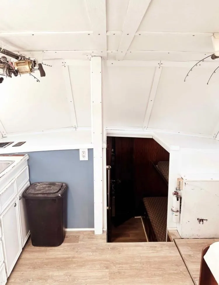 Slide: The Image of Interior of 1975 Hatteras 36 Convertible boat, featuring cabin entrance and kitchenette. - 6