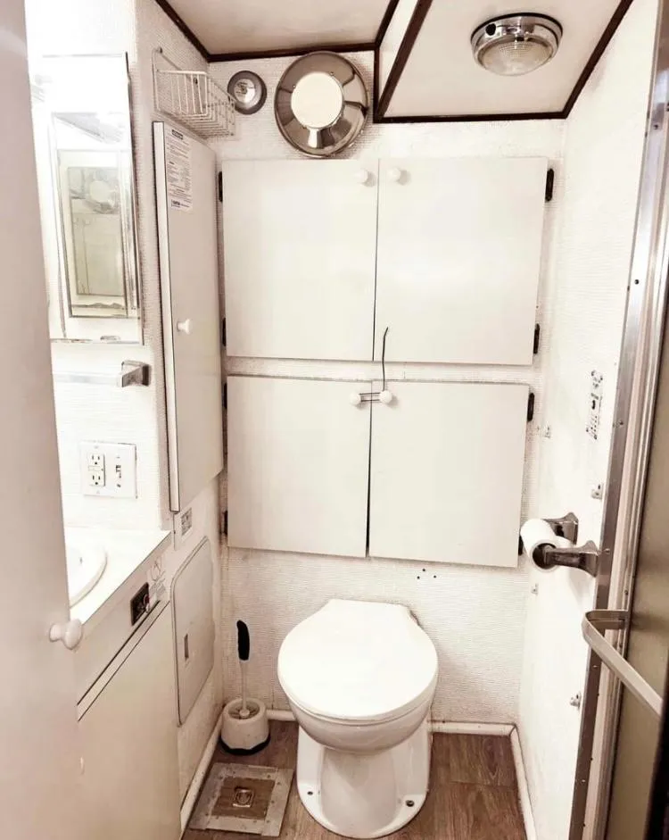 Slide: The Image of 1975 Hatteras 36 Convertible yacht bathroom with white cabinetry and modern fixtures. - 8