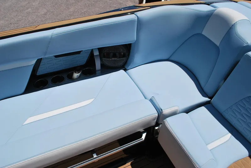 Slide: The Image of 2024 MasterCraft X26 interior with light blue seating and cup holders. - 14