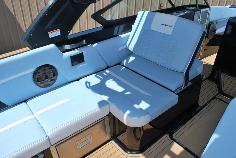 Slide: The Image of 2024 MasterCraft X26 boat interior with light blue seating and modern design. - 9