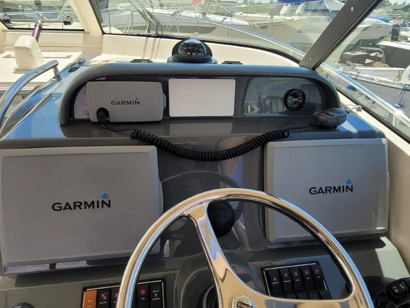 Slide: The Image of 2013 Pursuit 345 OS Offshore helm with Garmin navigation displays. - 14