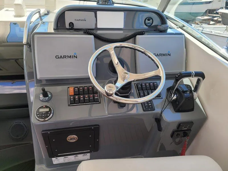 Slide: The Image of 2013 Pursuit 345 OS Offshore helm with Garmin navigation system and controls. - 15