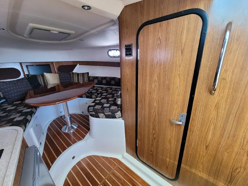 Slide: The Image of Interior of 2013 Pursuit 345 OS Offshore boat with wood accents and seating area. - 28