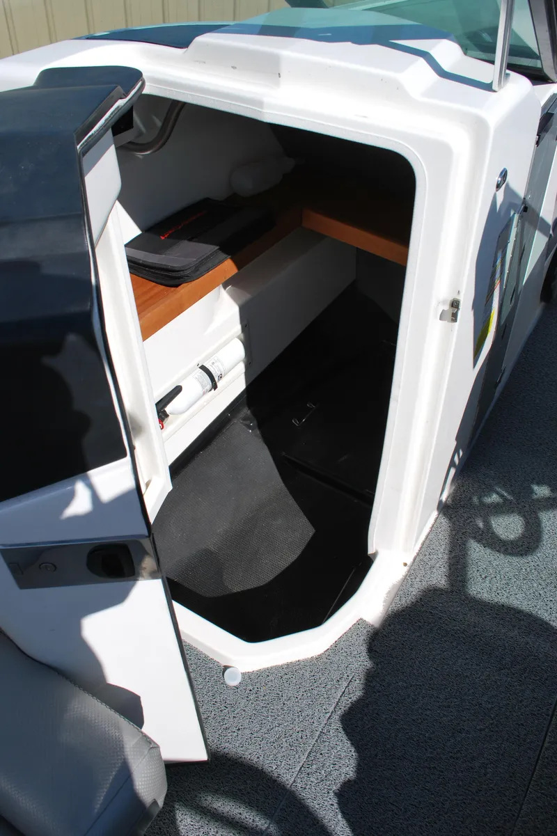 Slide: The Image of 2016 MasterCraft X26 boat interior cabin with seating and storage. - 12