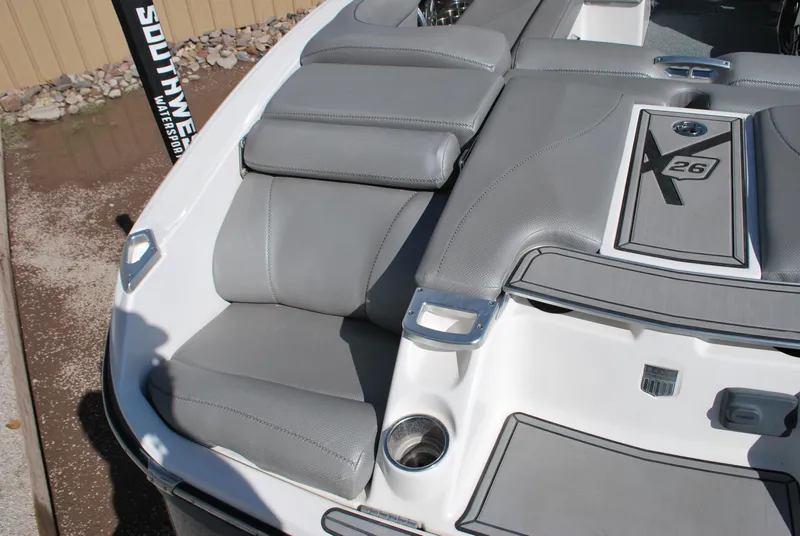 Slide: The Image of 2016 MasterCraft X26 boat with gray seating and sleek design. - 13