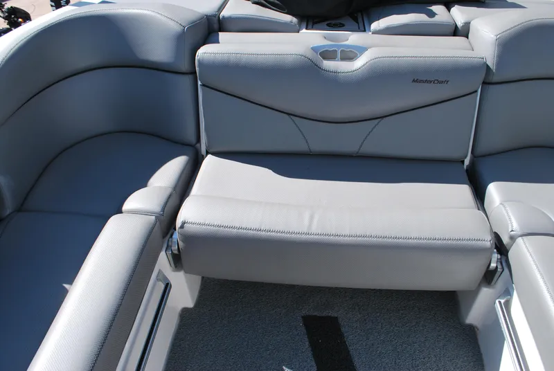 Slide: The Image of 2016 MasterCraft X26 boat interior with gray seating and sleek design. - 16