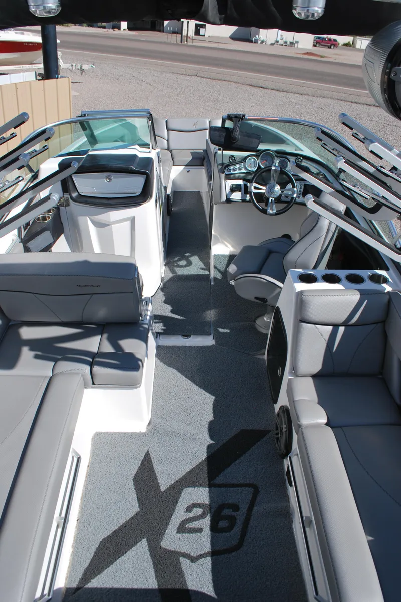 Slide: The Image of 2016 MasterCraft X26 boat interior with sleek seating and modern dashboard. - 19