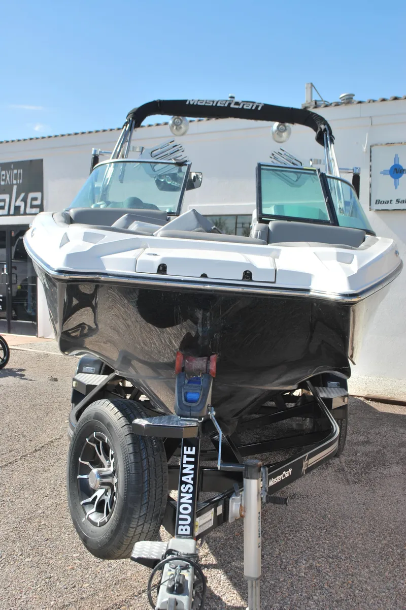 Slide: The Image of 2016 MasterCraft X26 boat on trailer, front view, outdoors. - 2