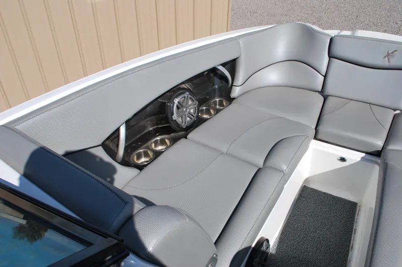 Slide: The Image of 2016 MasterCraft X26 boat interior with gray seating and built-in speaker system. - 4