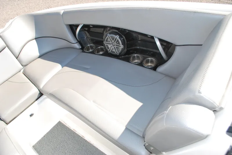 Slide: The Image of 2016 MasterCraft X26 boat interior with gray seating and built-in speakers. - 5