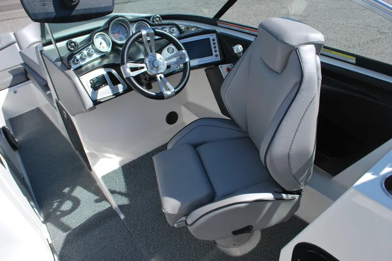 Slide: The Image of 2016 MasterCraft X26 boat interior with steering wheel and captain's chair. - 6