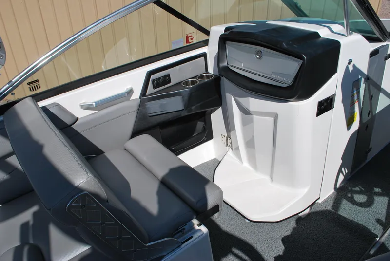 Slide: The Image of 2016 MasterCraft X26 boat interior with gray seating and modern dashboard. - 8
