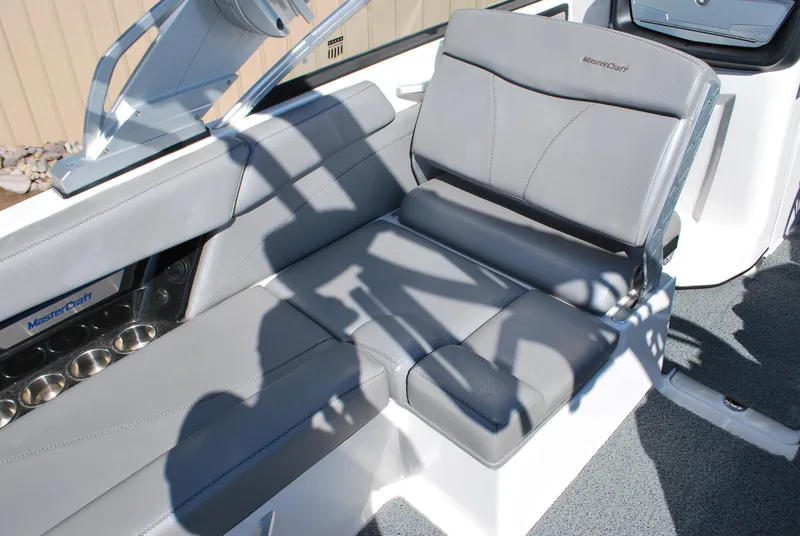 Slide: The Image of 2016 MasterCraft X26 boat interior with gray seating and modern design. - 9
