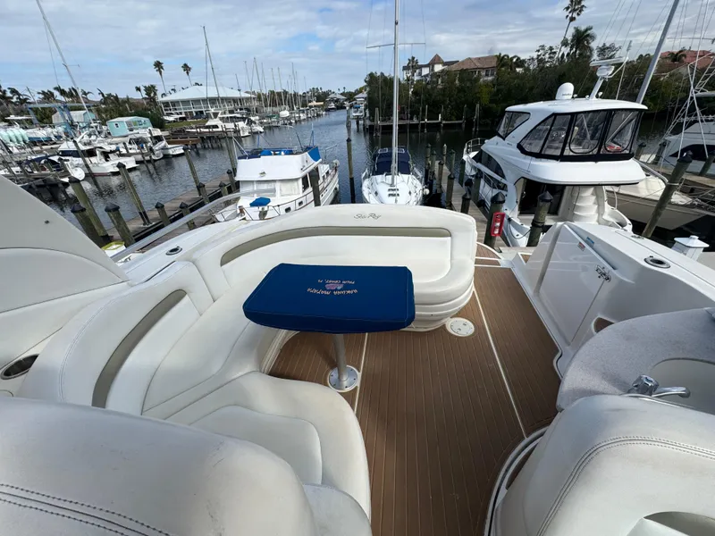 Slide: The Image of 2006 Sea Ray 320 Sundancer V-Drive yacht with spacious deck seating in marina. - 13