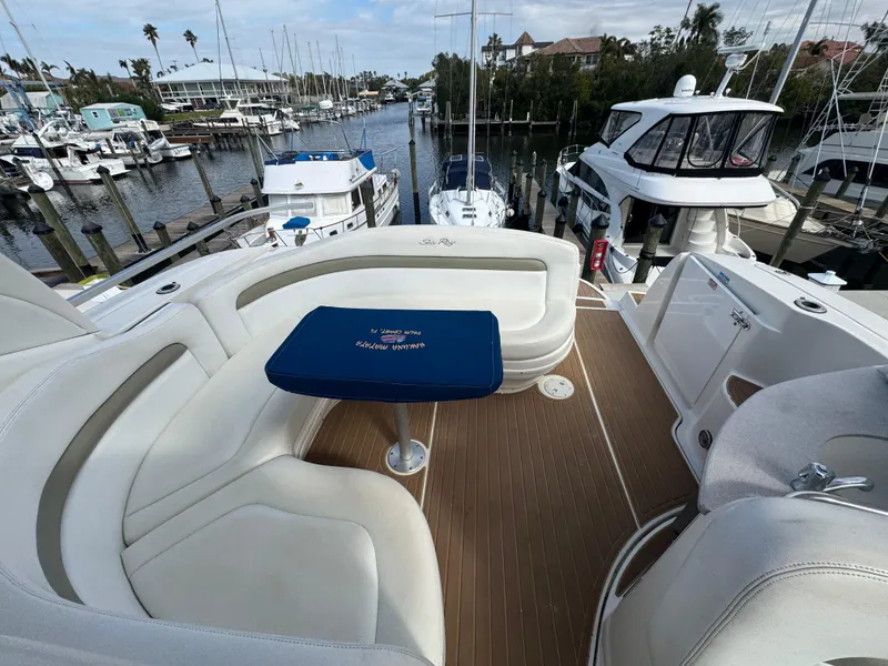 Slide: The Image of 2006 Sea Ray 320 Sundancer V-Drive yacht interior with white seating and marina view. - 15
