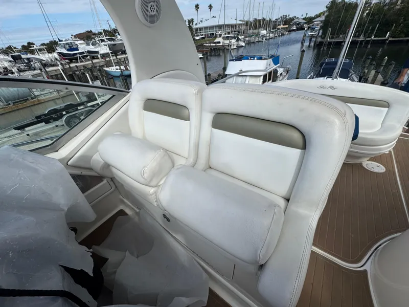 Slide: The Image of 2006 Sea Ray 320 Sundancer V-Drive boat interior with white seating at marina. - 17