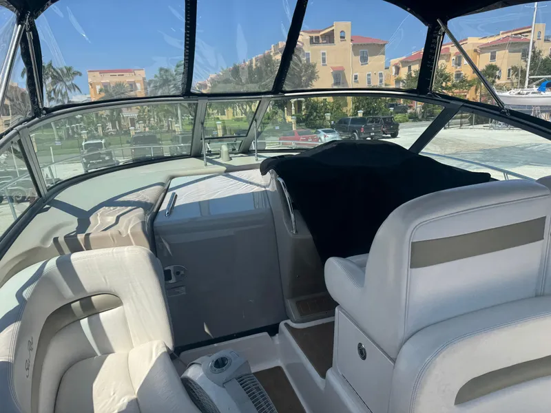 Slide: The Image of 2006 Sea Ray 320 Sundancer V-Drive interior with white seating and dashboard view. - 21