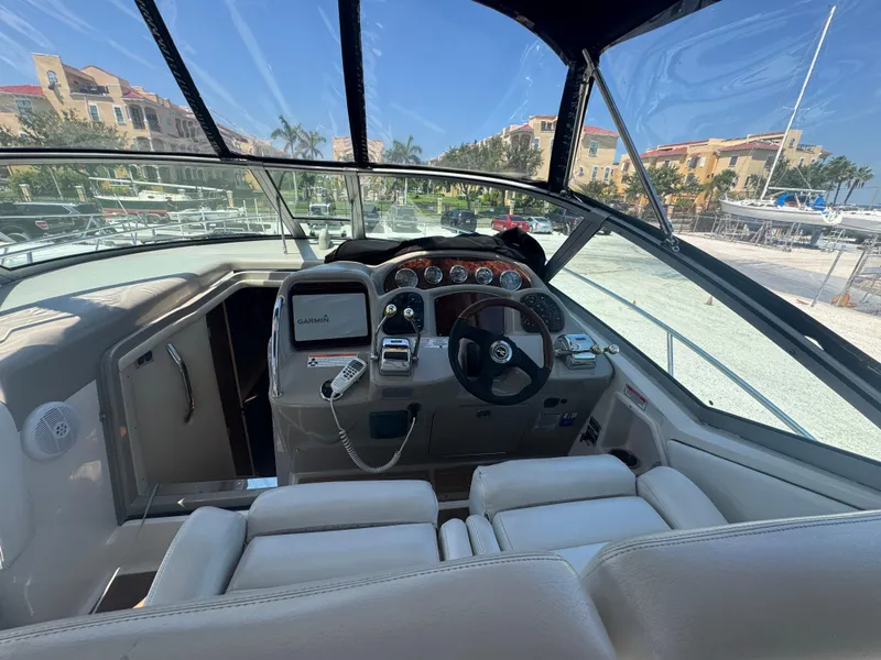 Slide: The Image of 2006 Sea Ray 320 Sundancer V-Drive cockpit with steering wheel and navigation equipment. - 24